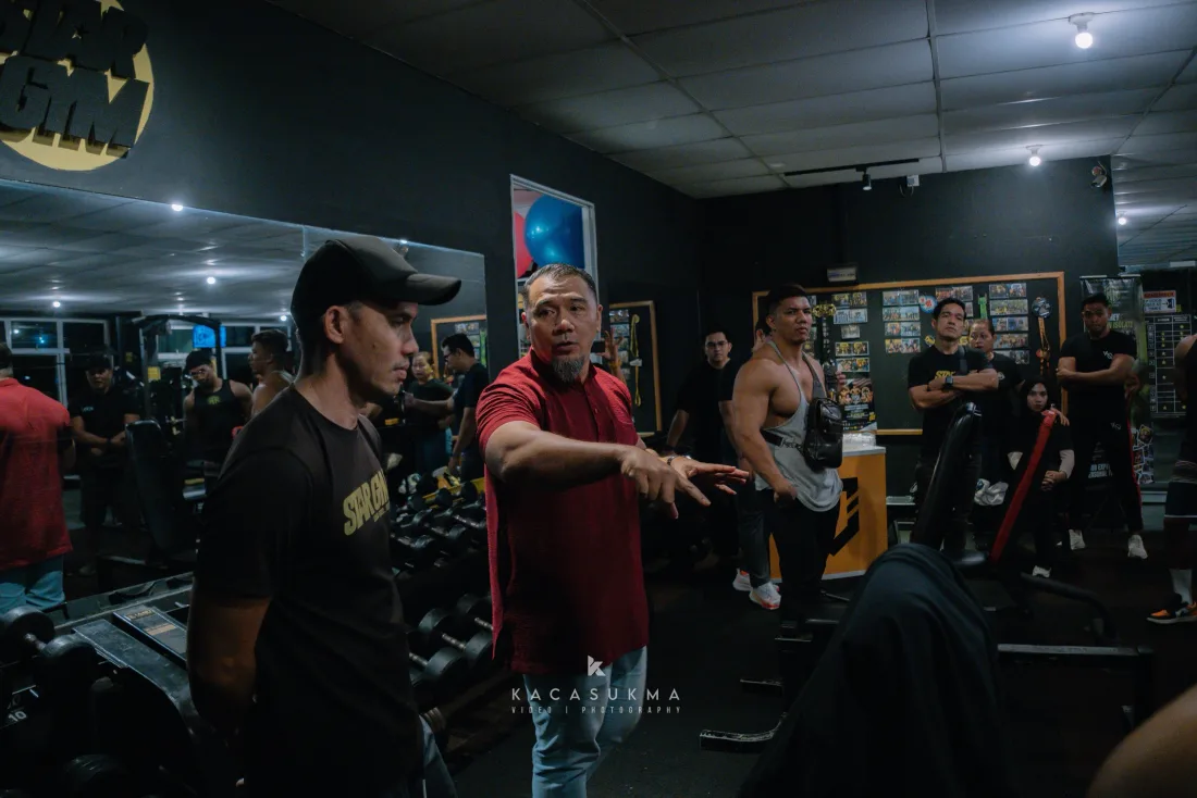 Coach briefing a group of athletes before they go on stage
